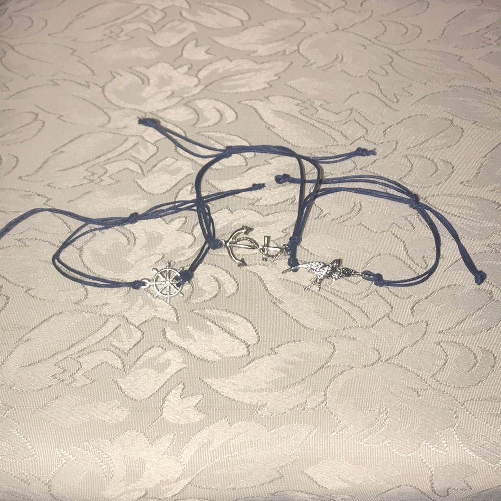 Anchor, bird, and wheel bracelets
